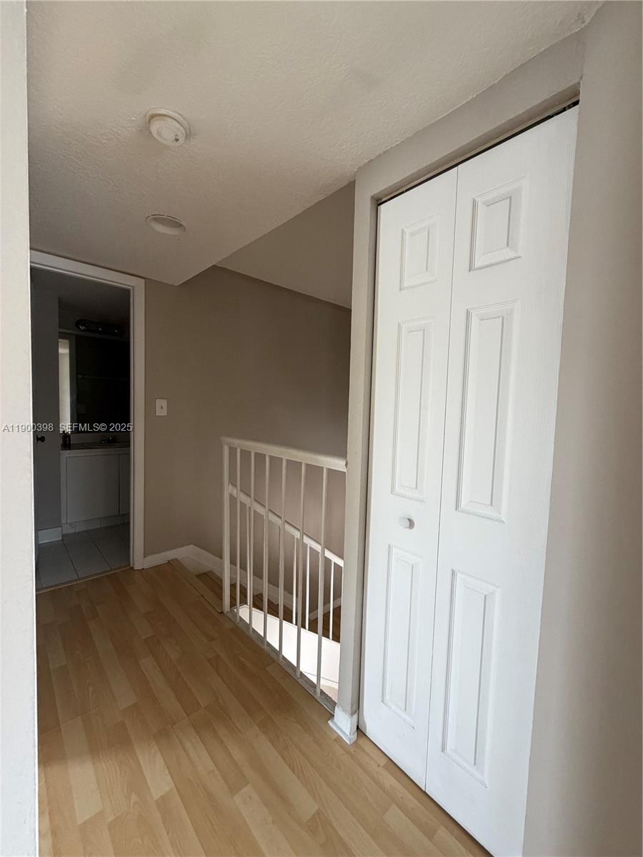 4515 Southwest 68th Ct Circle, Unit 1 Miami, FL 33155 - Photo 14 of 16 an empty room with wooden floor and a bathroom