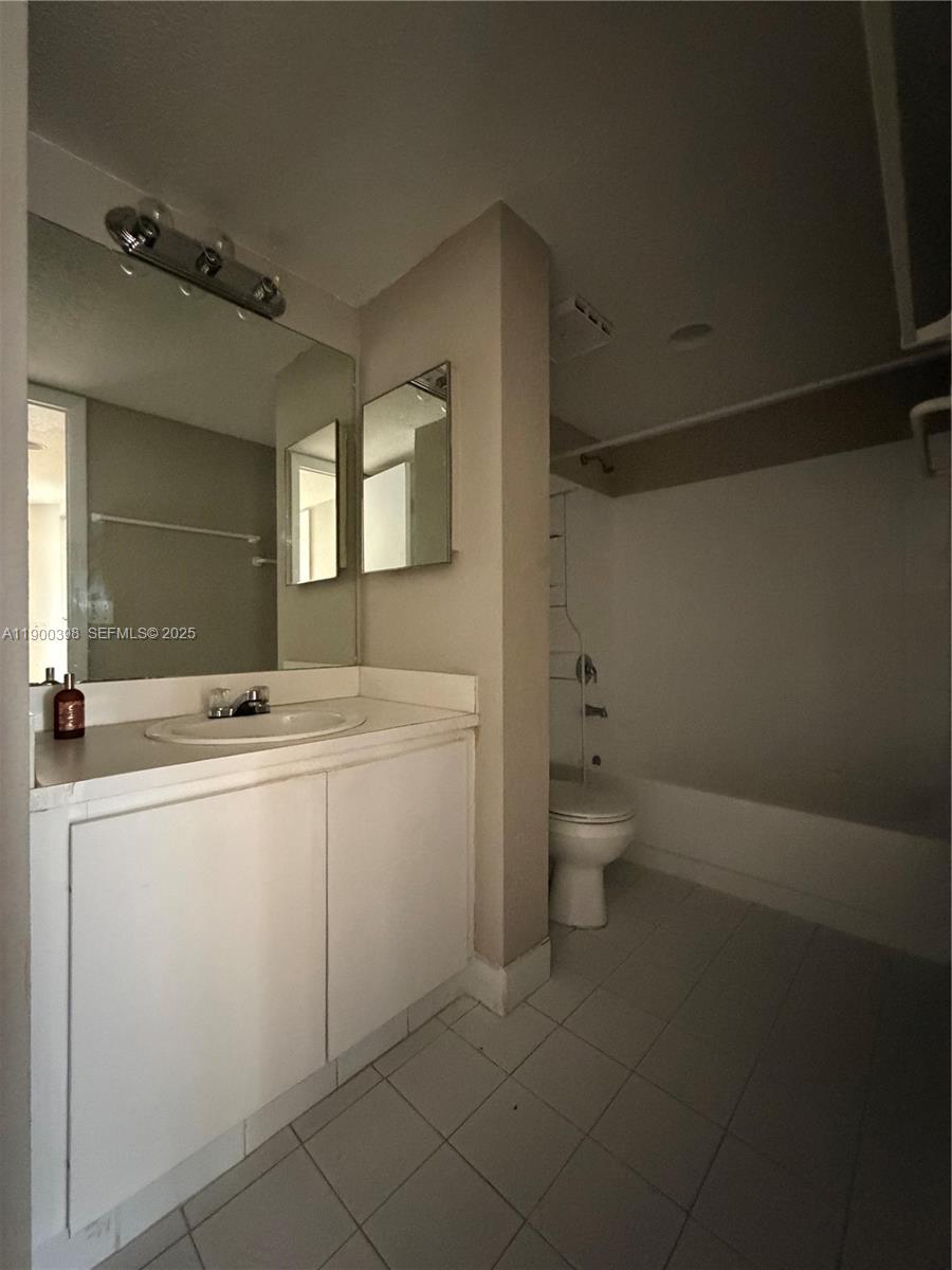 4515 Southwest 68th Ct Circle, Unit 1 Miami, FL 33155 - Photo 15 of 16 a view of bathroom with a sink toilet and a mirror