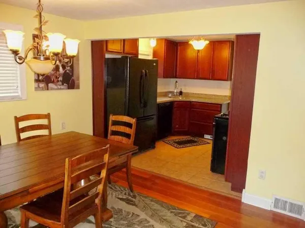 a dining room with furniture and chandelier