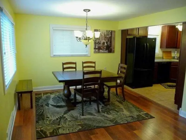 a kitchen with granite countertop a refrigerator and a sink