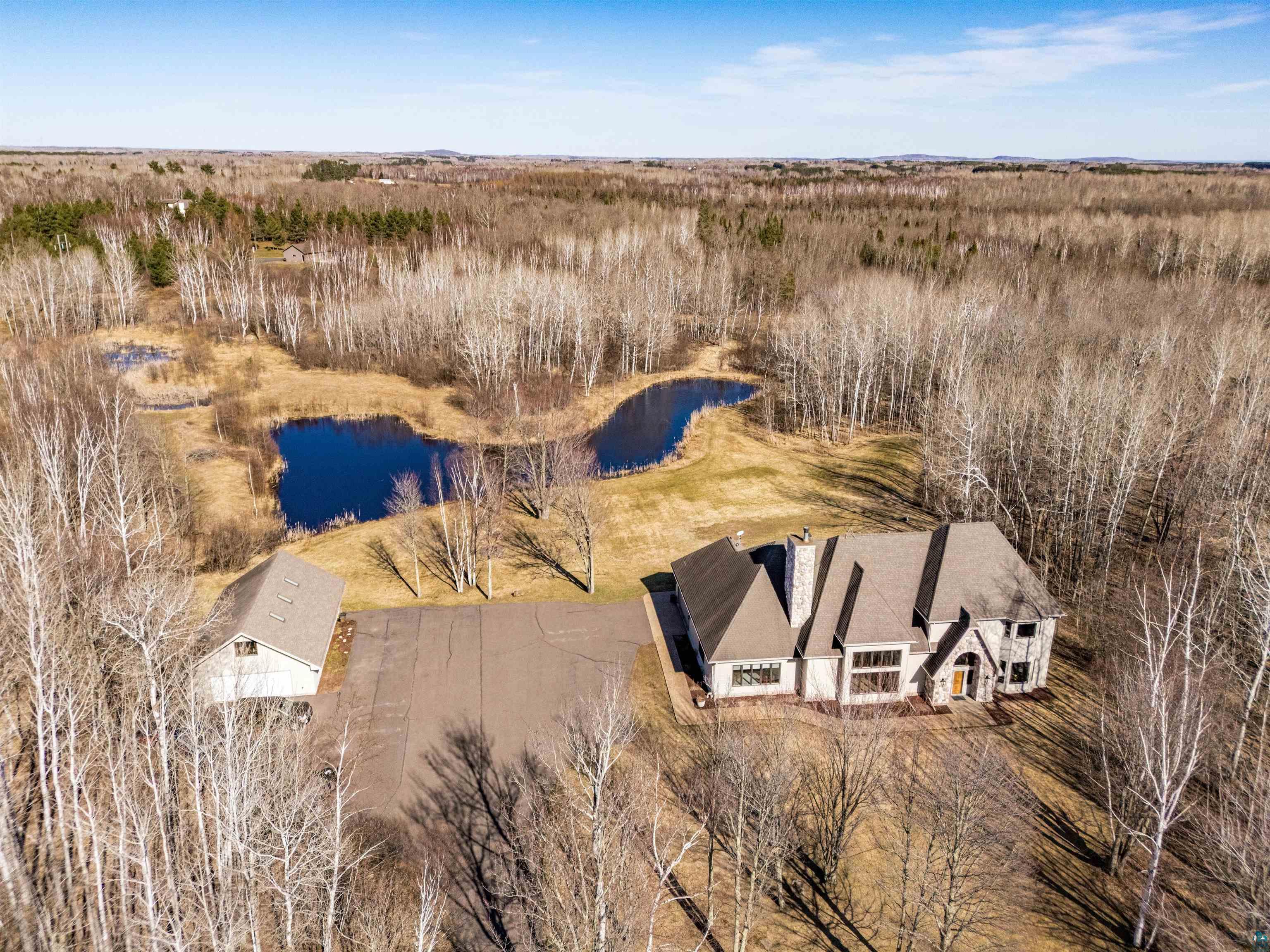 390 Crosby Road Cloquet, MN 55720 - Photo 38 of 41 Expansive property featuring a large residence, separate outbuilding, and a private pond