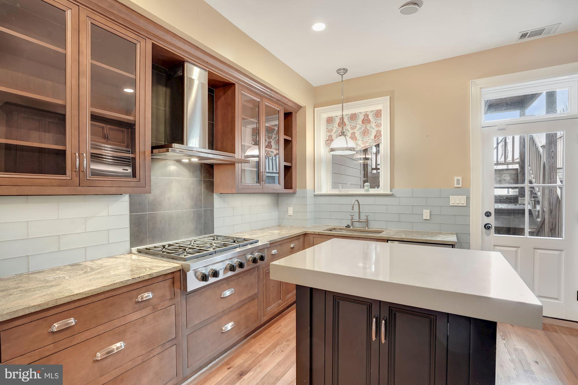 2721 2721-upper Ontario Road Northwest Washington, DC 20009 - Photo 11 of 31 a kitchen with stainless steel appliances granite countertop a sink stove and cabinets
