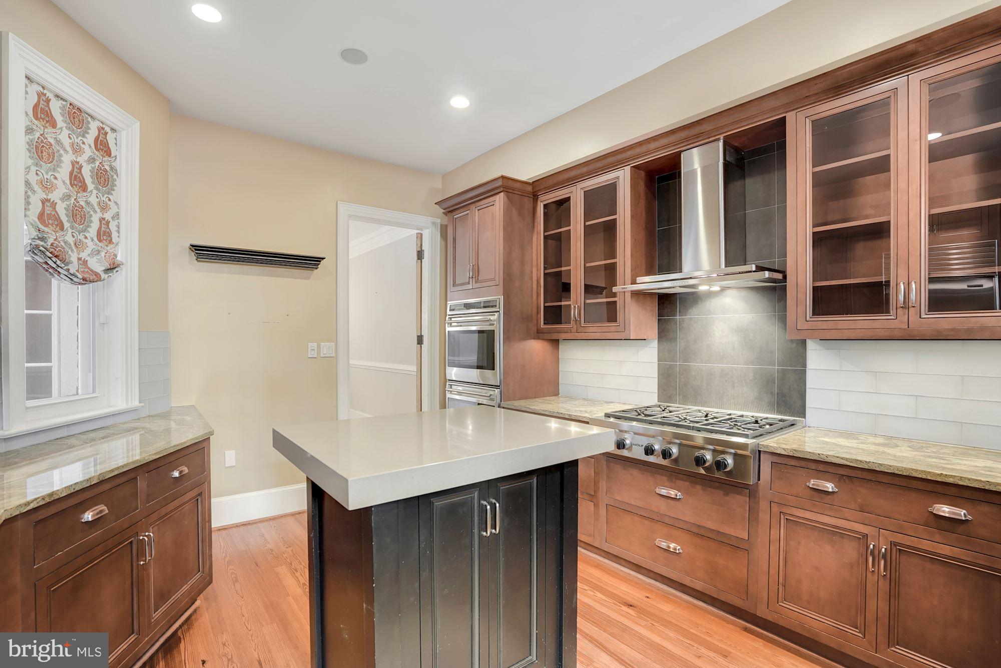 2721 2721-upper Ontario Road Northwest Washington, DC 20009 - Photo 12 of 31 a kitchen with stainless steel appliances granite countertop a stove and a sink