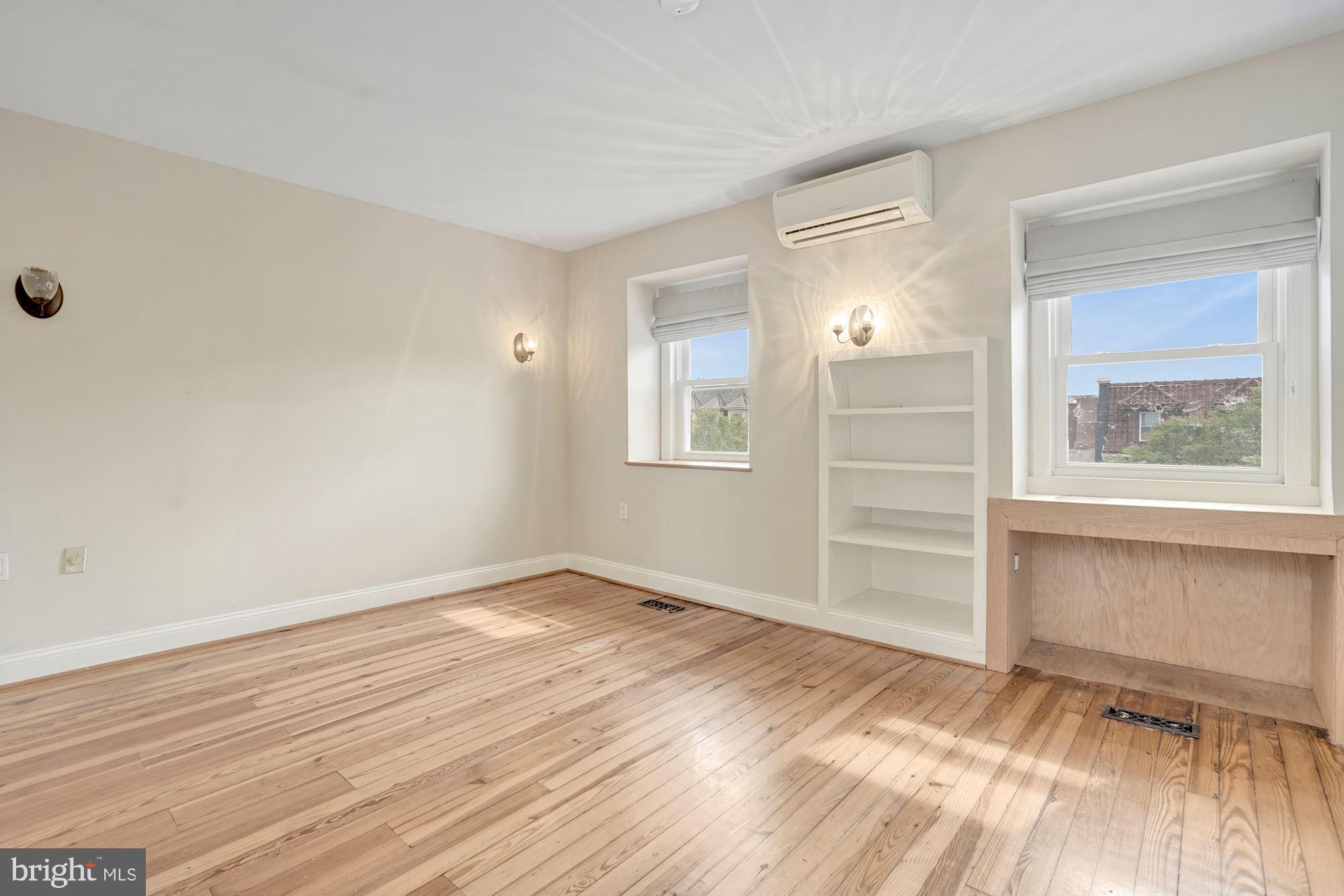 2721 2721-upper Ontario Road Northwest Washington, DC 20009 - Photo 17 of 31 an empty room with wooden floor and windows