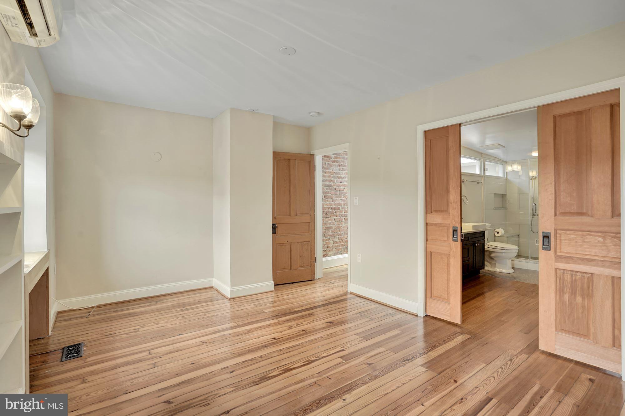 2721 2721-upper Ontario Road Northwest Washington, DC 20009 - Photo 18 of 31 a view of a big room with wooden floor and windows