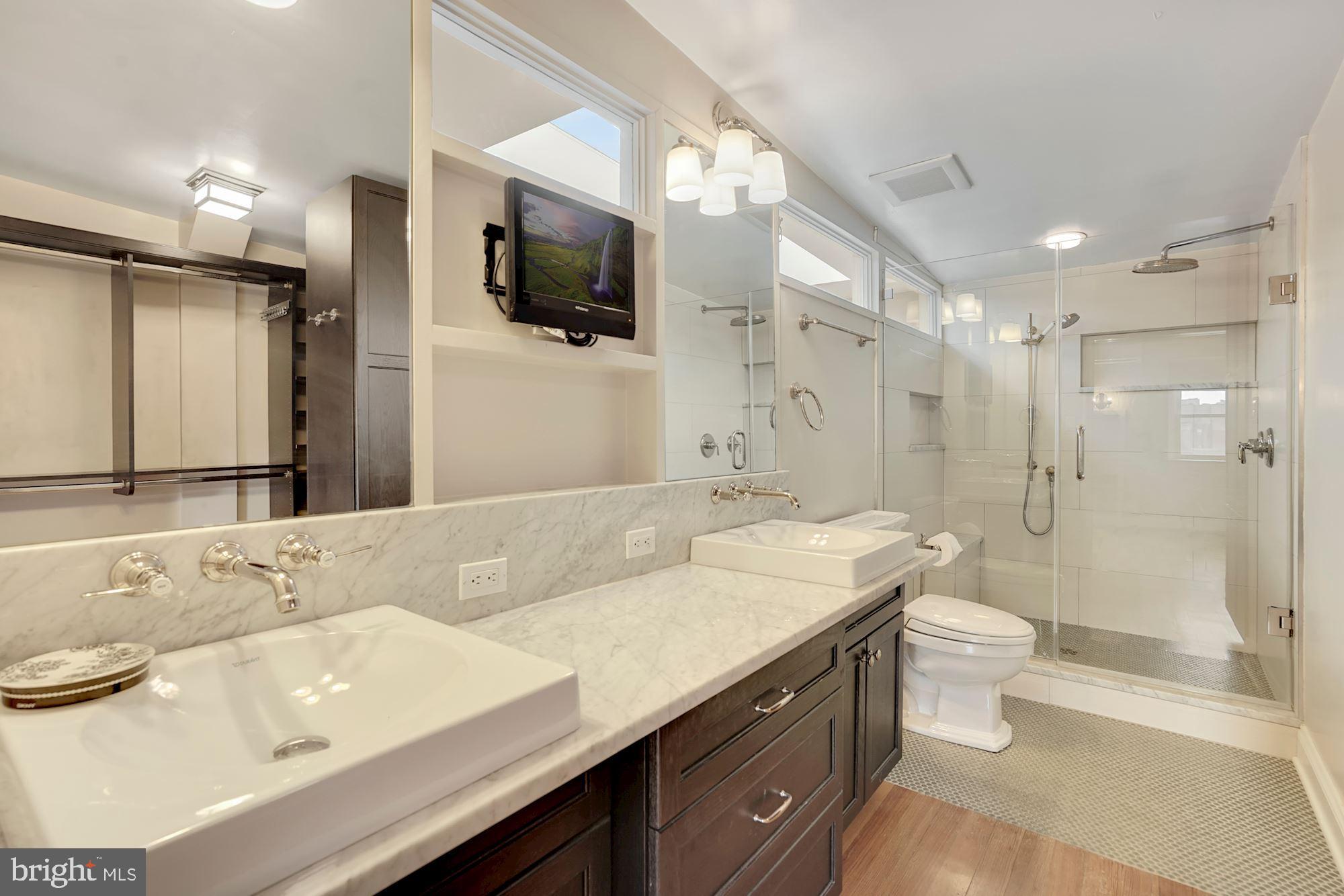 2721 2721-upper Ontario Road Northwest Washington, DC 20009 - Photo 19 of 31 a bathroom with a sink a toilet and shower