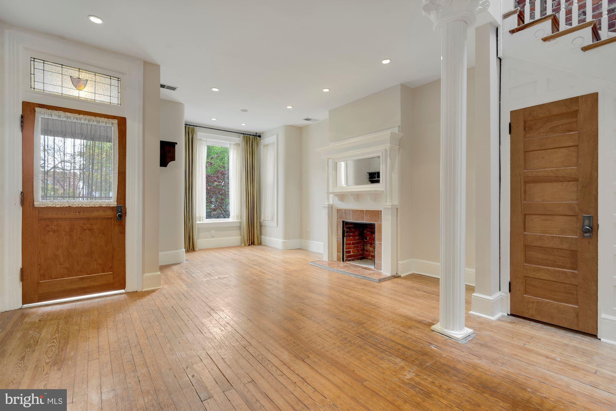 2721 2721-upper Ontario Road Northwest Washington, DC 20009 - Photo 3 of 31 a view of empty room with wooden floor and fireplace