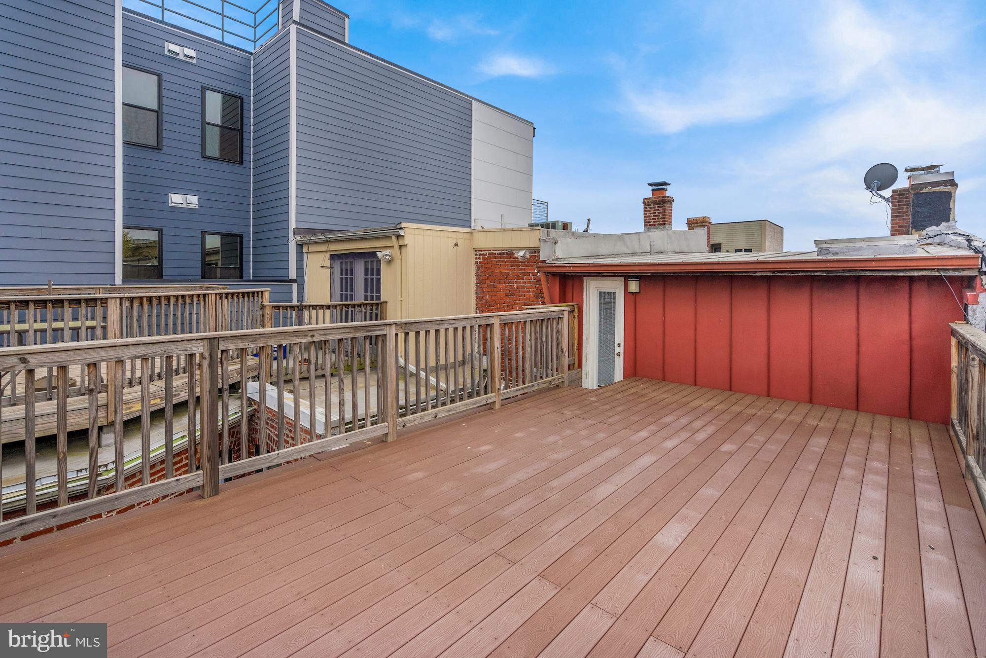2721 2721-upper Ontario Road Northwest Washington, DC 20009 - Photo 24 of 31 a view of a wooden deck and city view