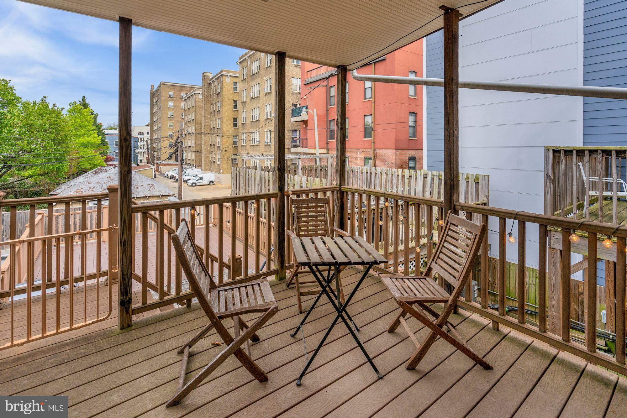 2721 2721-upper Ontario Road Northwest Washington, DC 20009 - Photo 26 of 31 a view of a balcony with wooden floor next to a iron stairs