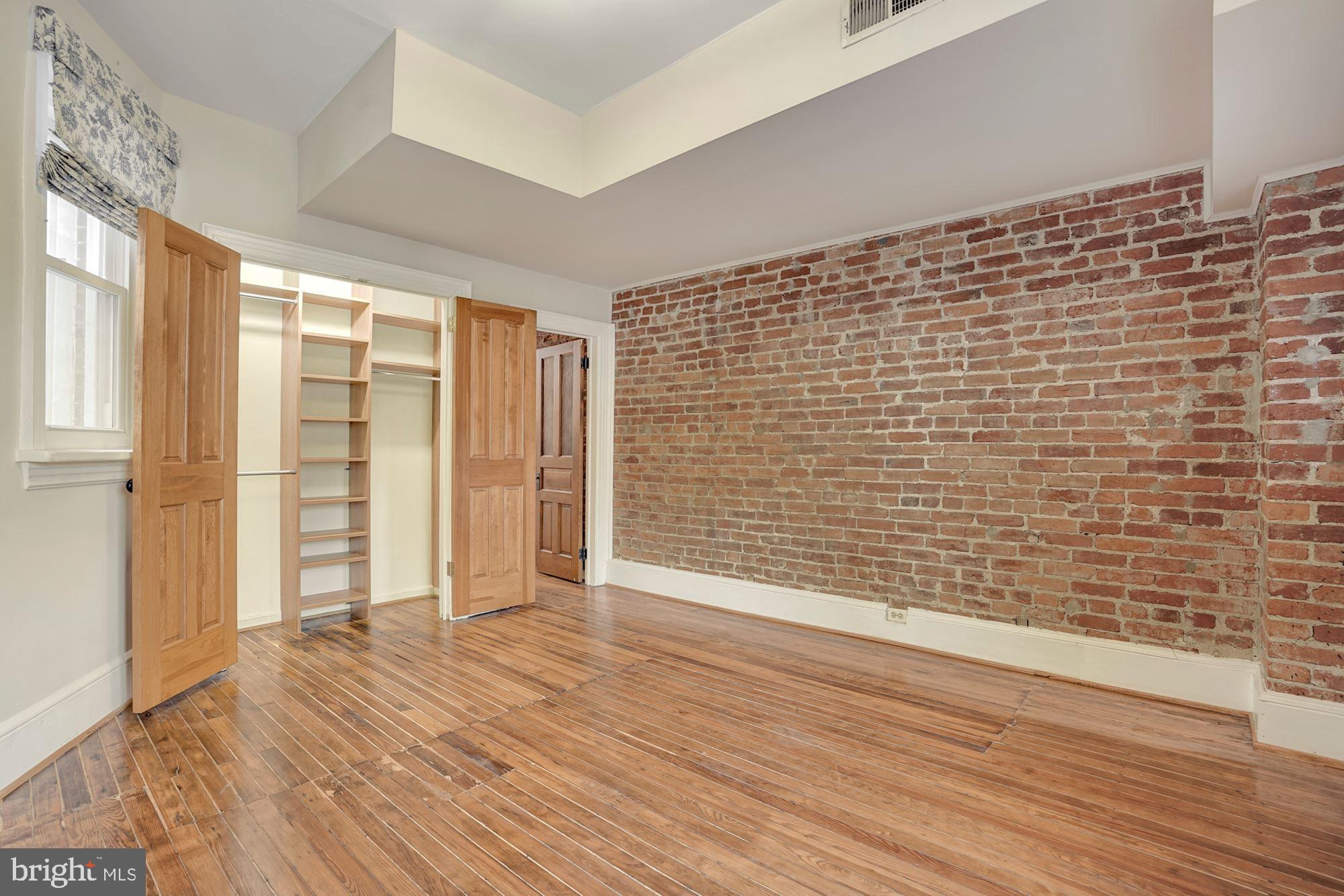 2721 2721-upper Ontario Road Northwest Washington, DC 20009 - Photo 27 of 31 a view of an empty room with wooden floor and a window