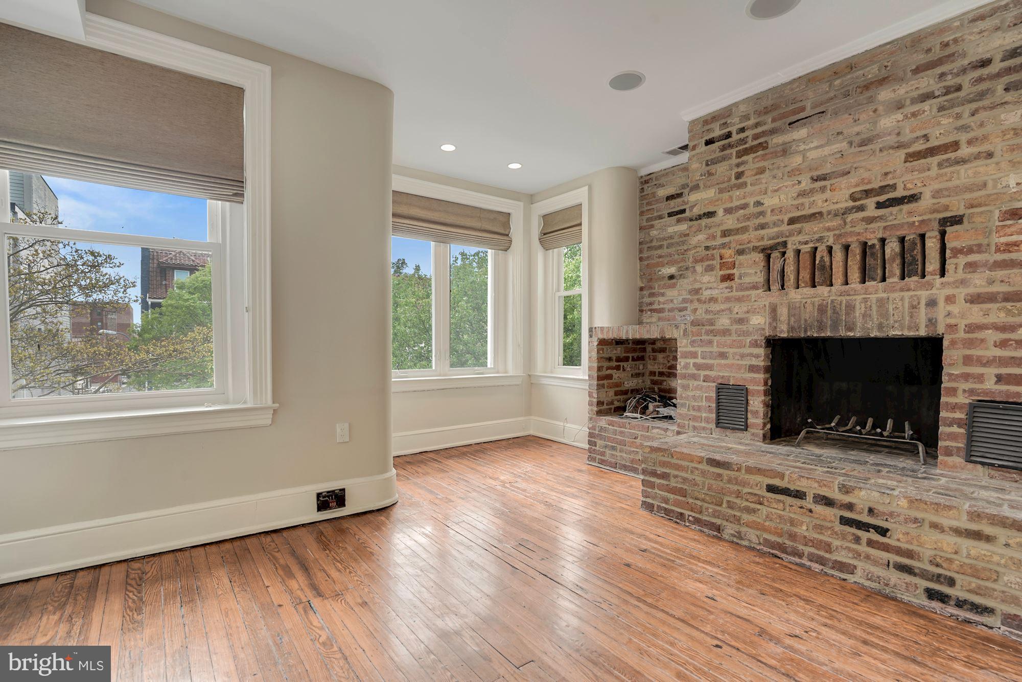 2721 2721-upper Ontario Road Northwest Washington, DC 20009 - Photo 29 of 31 a view of a livingroom with a fireplace and window