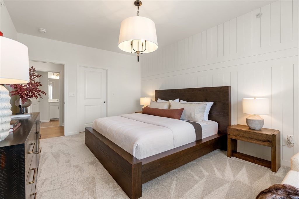 6 Stratton Drive, Unit 303 Woburn, MA 01801 - Photo 17 of 21 a bedroom with bed and a chandelier