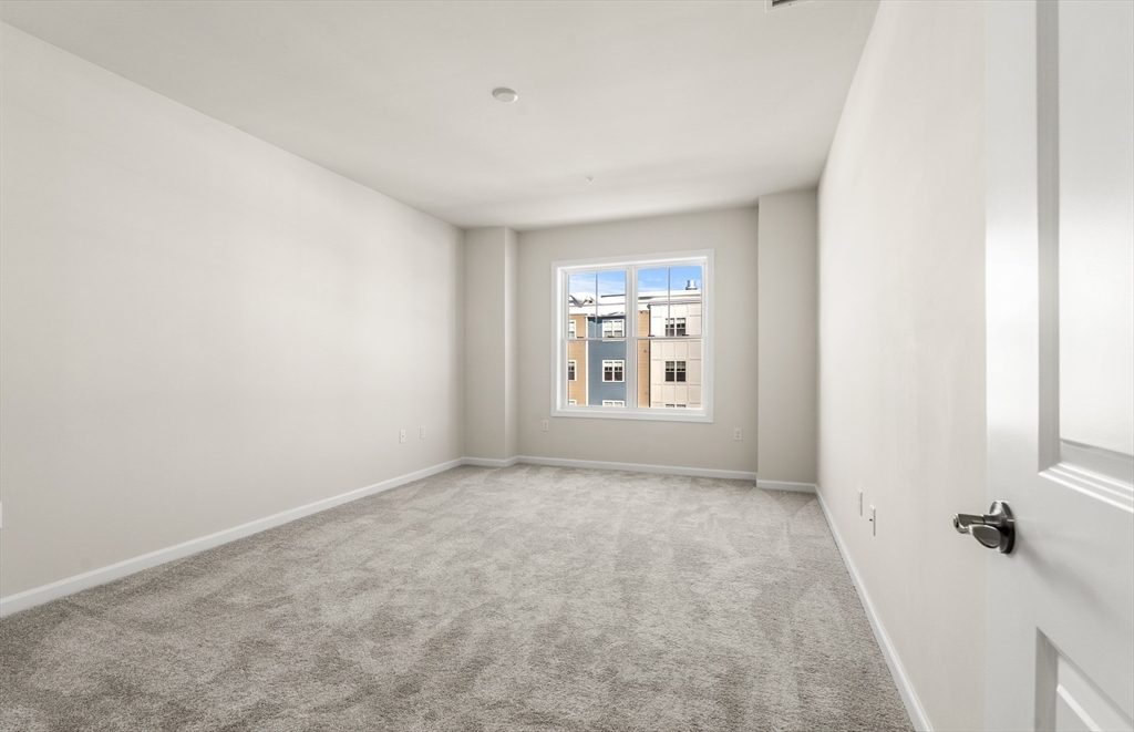 6 Stratton Drive, Unit 303 Woburn, MA 01801 - Photo 20 of 29 an empty room with windows