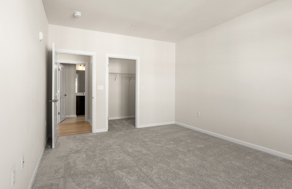 6 Stratton Drive, Unit 303 Woburn, MA 01801 - Photo 23 of 29 an empty room with a bathroom and a sink