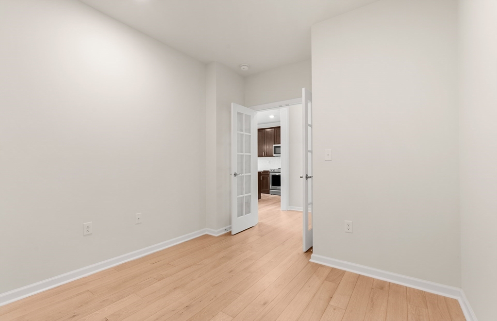 6 Stratton Drive, Unit 303 Woburn, MA 01801 - Photo 9 of 29 wooden floor in an empty room