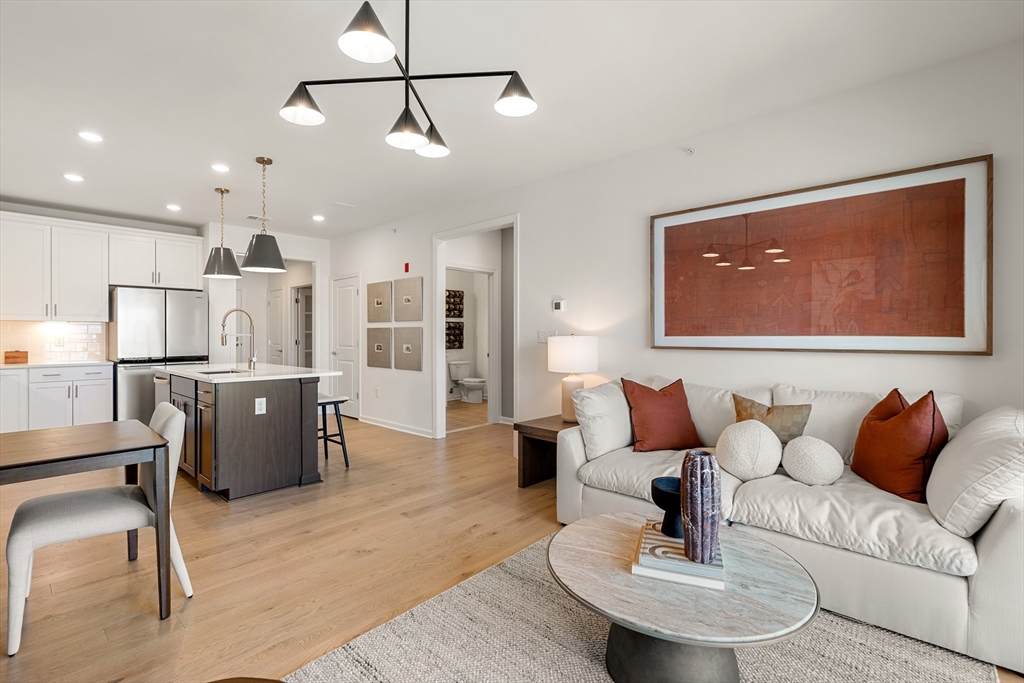 6 Stratton Drive, Unit 303 Woburn, MA 01801 - Photo 10 of 21 a living room with furniture and kitchen view