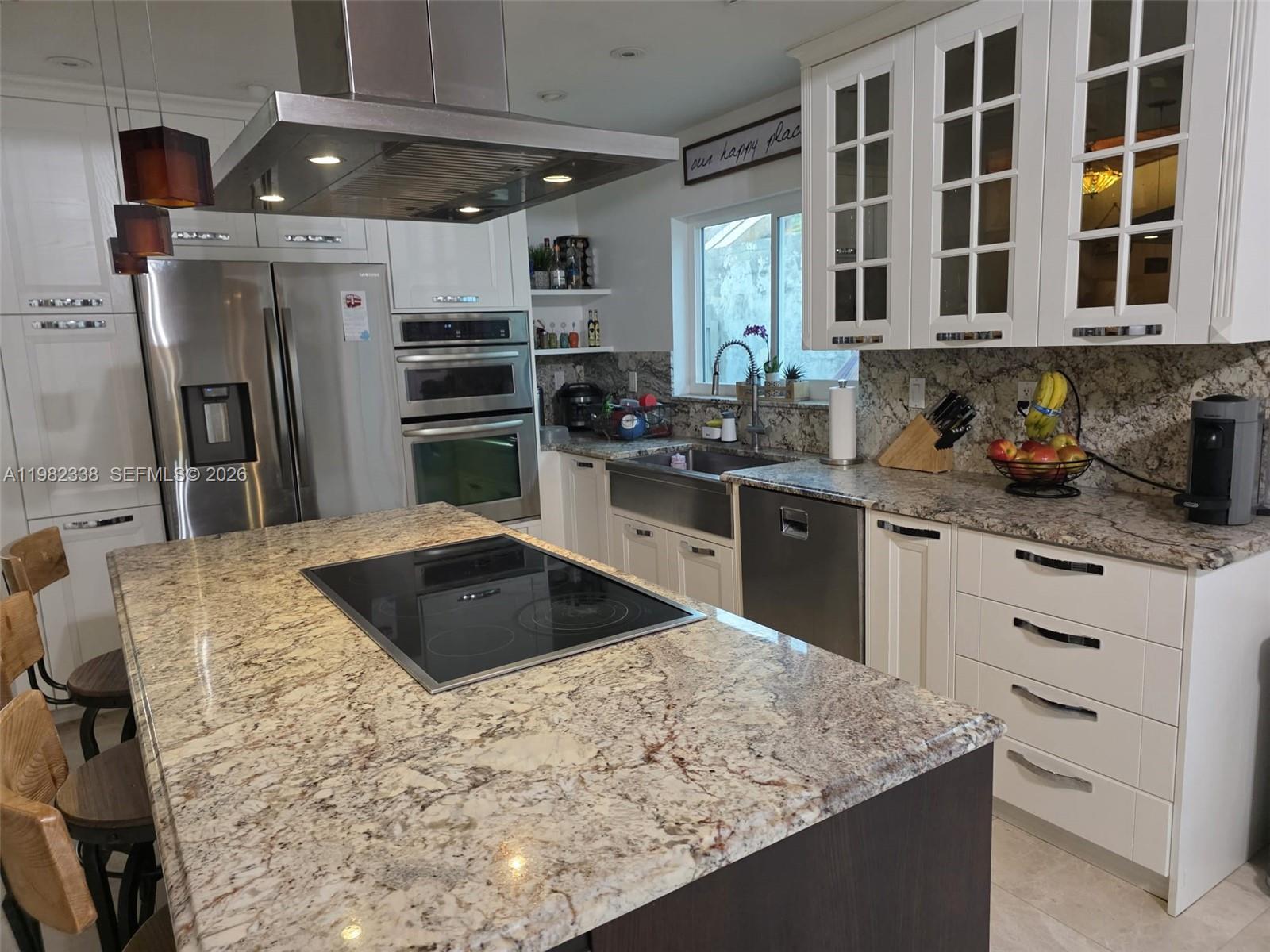 14530 Southwest 110th Street Miami, FL 33186 - Photo 12 of 45 a kitchen with stainless steel appliances kitchen island granite countertop a sink stove and refrigerator