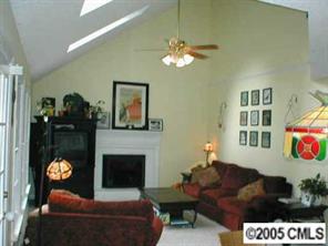 12733 Moores Mill Road Huntersville, NC 28078 - Photo 7 of 8 a living room with furniture a lamp and a fireplace