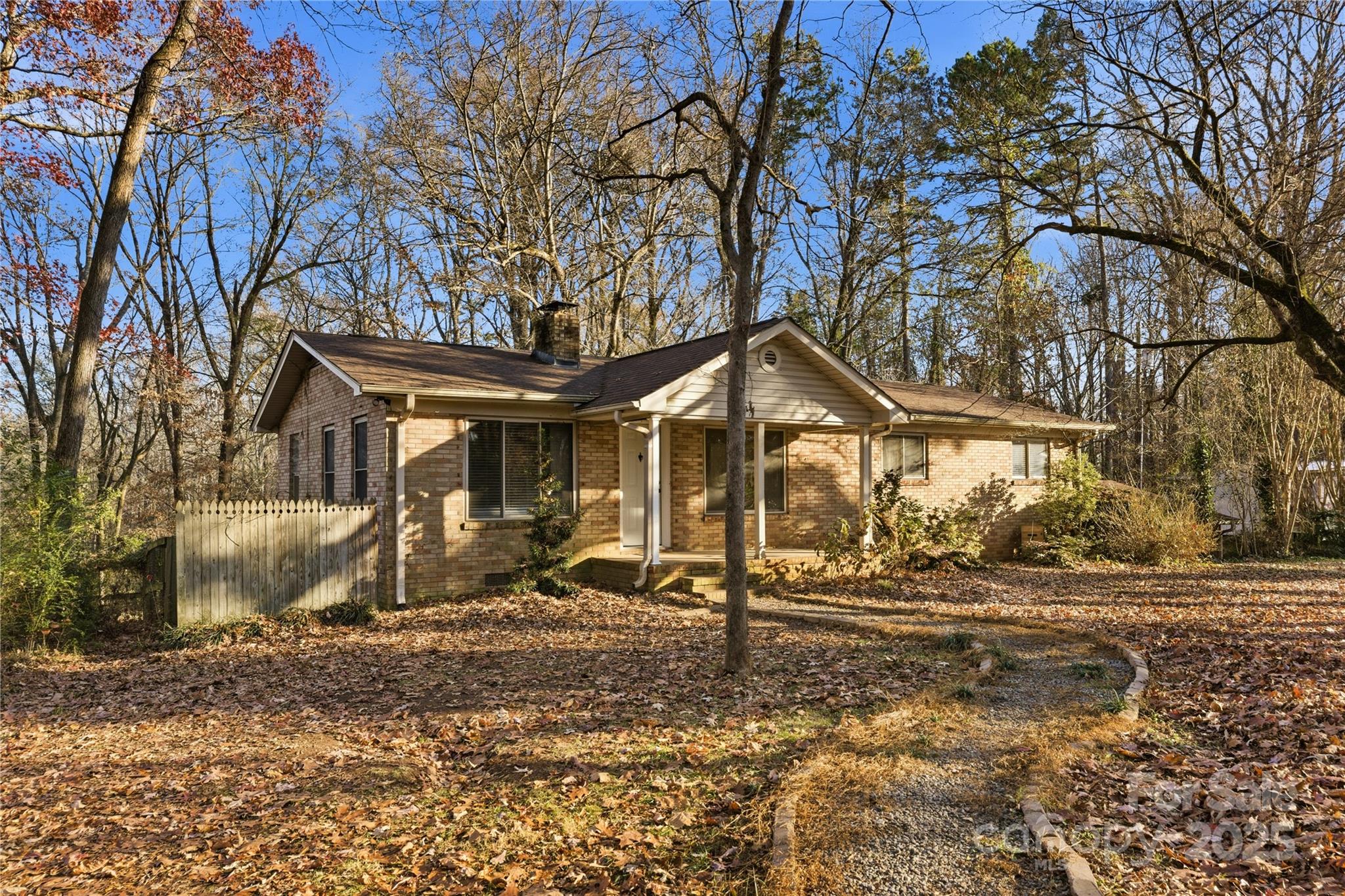 a view of a house with a yard and the trees