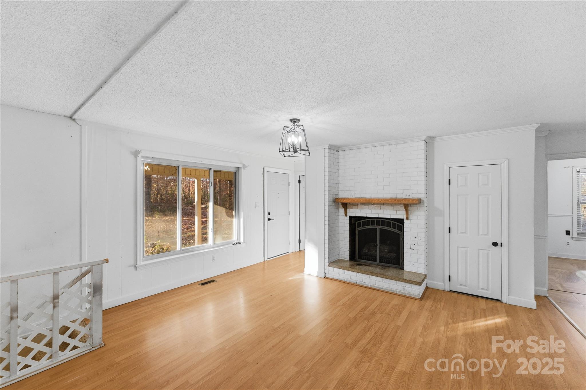 1051 Cox Mill Road Concord, NC 28027 - Photo 11 of 48 an empty room with windows fireplace and windows