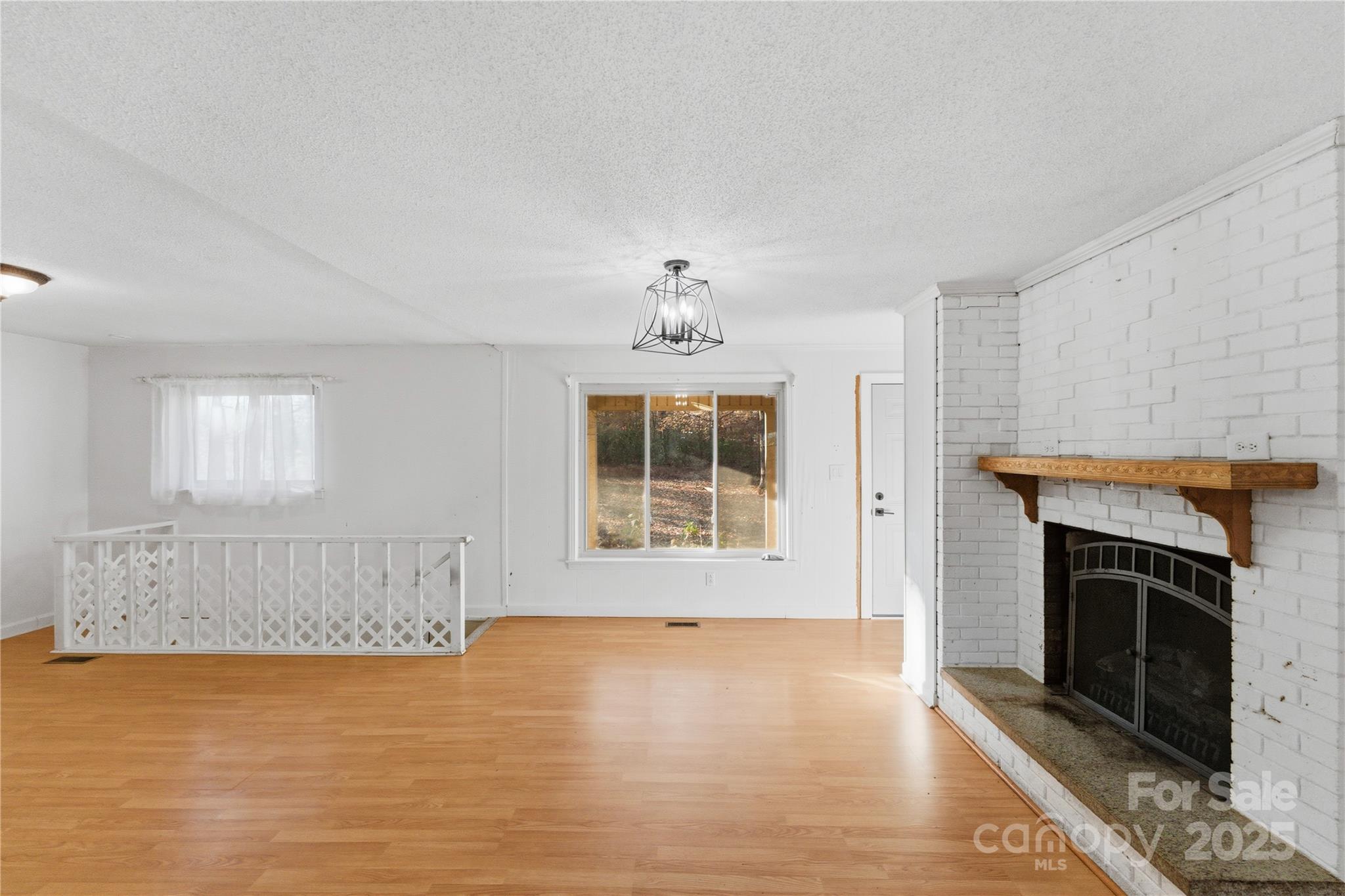 1051 Cox Mill Road Concord, NC 28027 - Photo 14 of 48 a view of an empty room with a window and fireplace