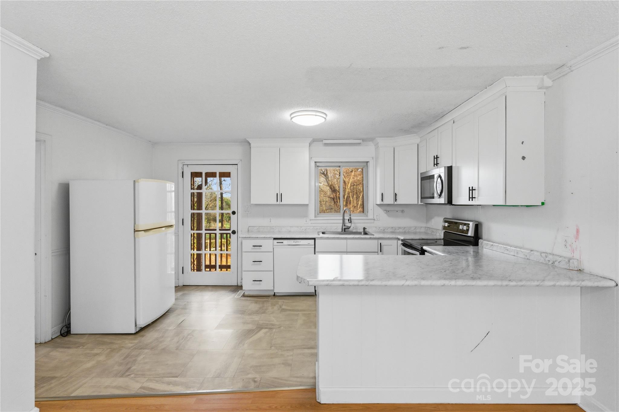 1051 Cox Mill Road Concord, NC 28027 - Photo 15 of 48 a kitchen with stainless steel appliances granite countertop a stove a sink a refrigerator and white cabinets
