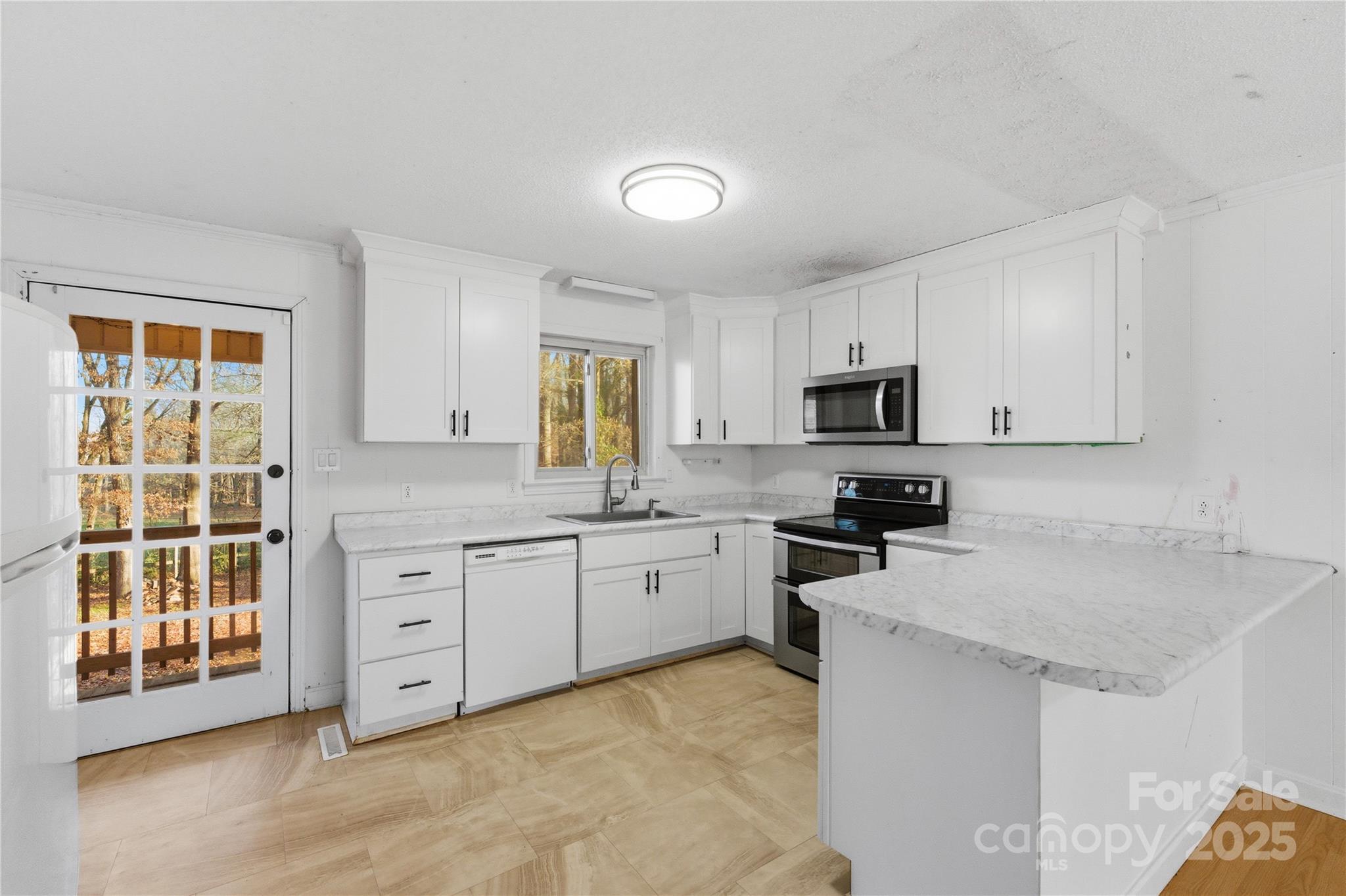 1051 Cox Mill Road Concord, NC 28027 - Photo 16 of 48 a kitchen with granite countertop a stove sink and microwave