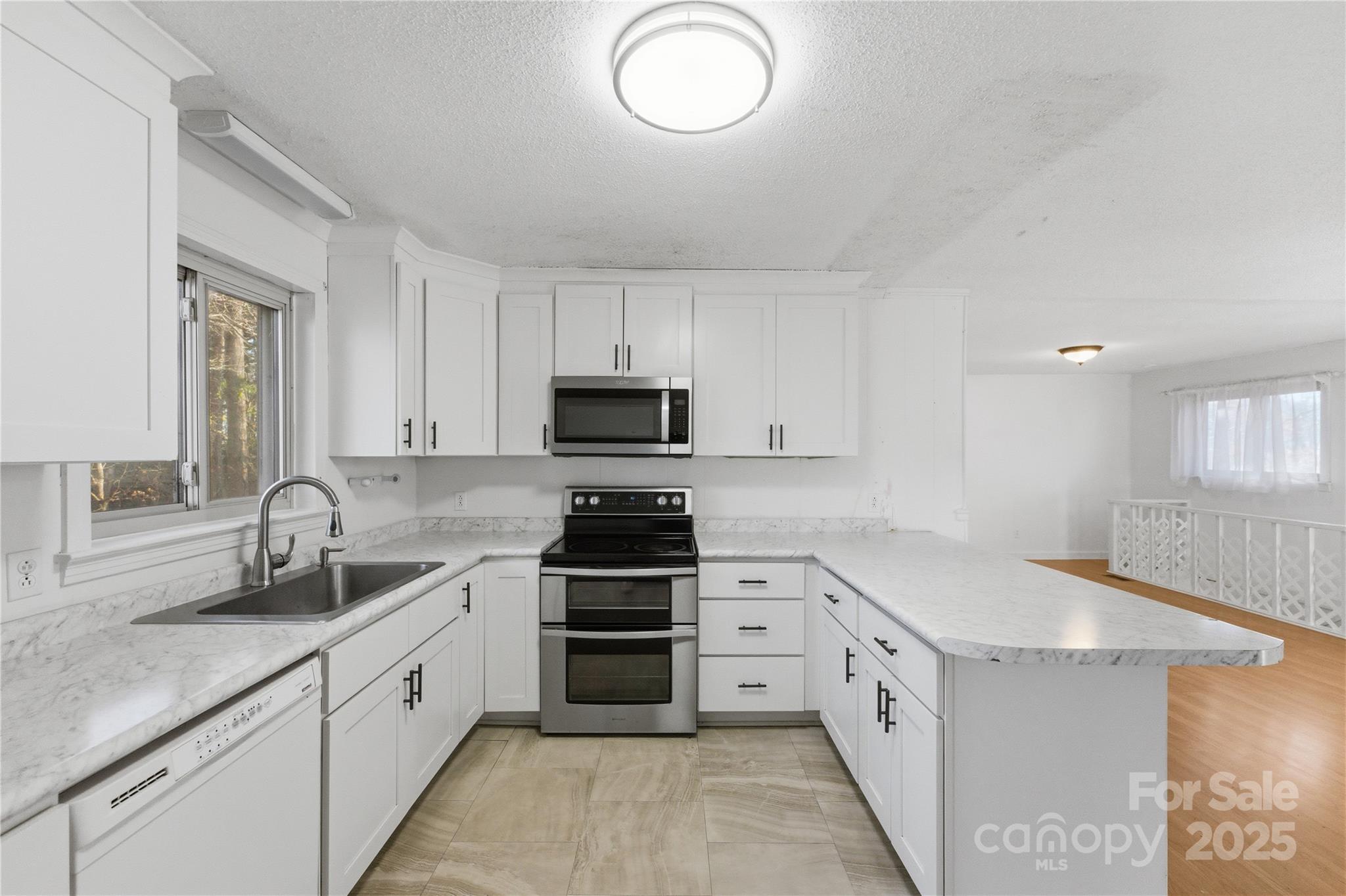 1051 Cox Mill Road Concord, NC 28027 - Photo 17 of 48 a kitchen with granite countertop a sink stove and cabinets