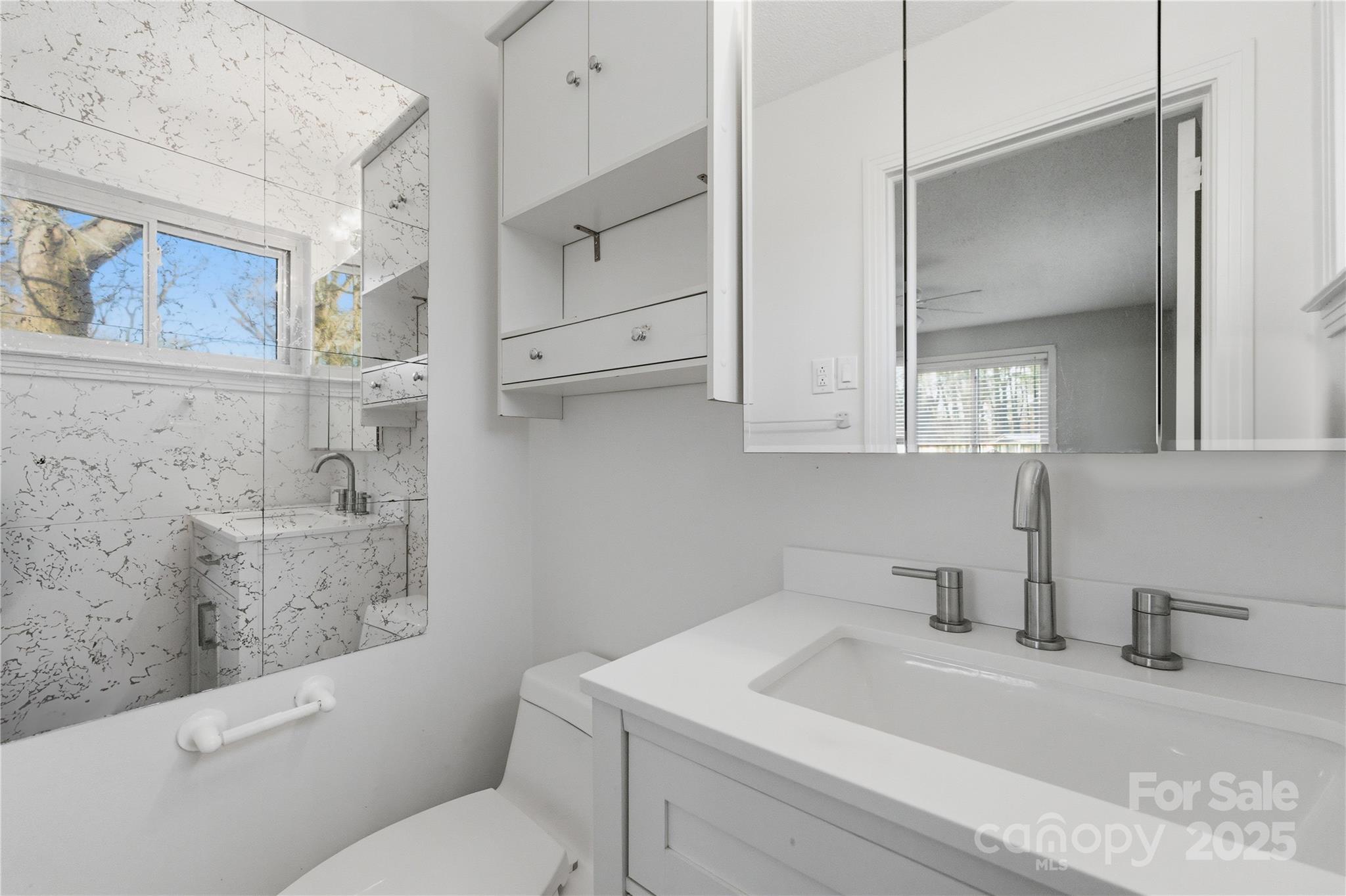 1051 Cox Mill Road Concord, NC 28027 - Photo 27 of 48 a bathroom with a sink a toilet and vanity