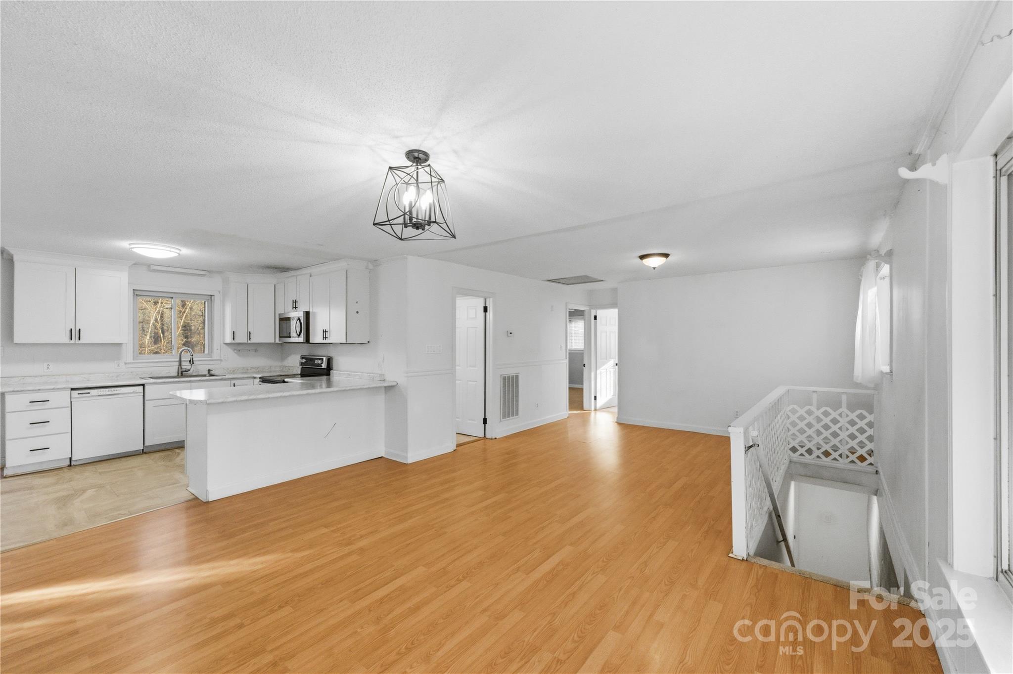 1051 Cox Mill Road Concord, NC 28027 - Photo 7 of 48 a large white kitchen with kitchen island a sink stainless steel appliances and cabinets