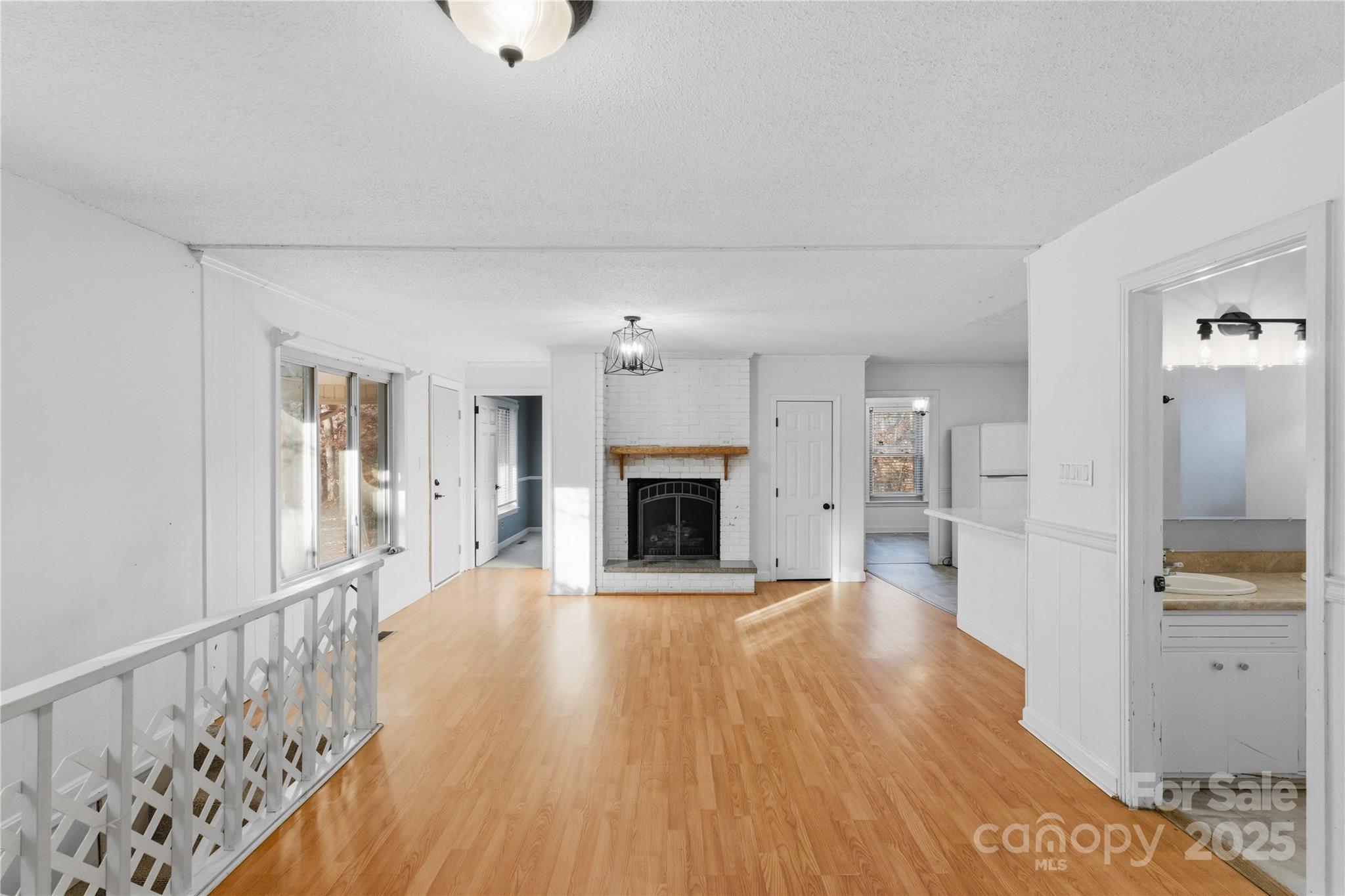 1051 Cox Mill Road Concord, NC 28027 - Photo 10 of 48 a view of a hallway with wooden floor and a fireplace