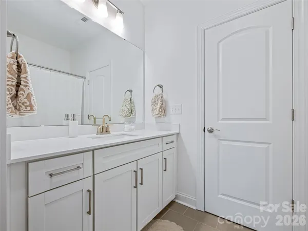 a bathroom with a double vanity sink and a mirror