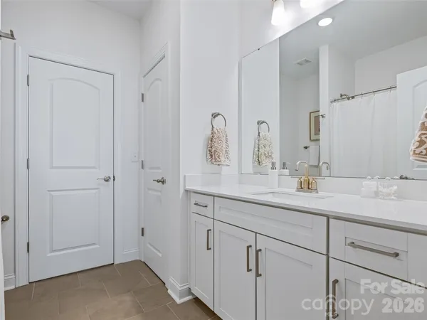 a bathroom with a double vanity sink and mirror