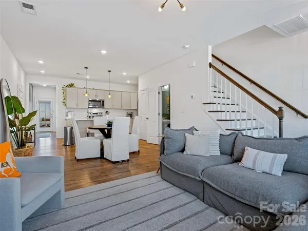 a living room with furniture and wooden floor