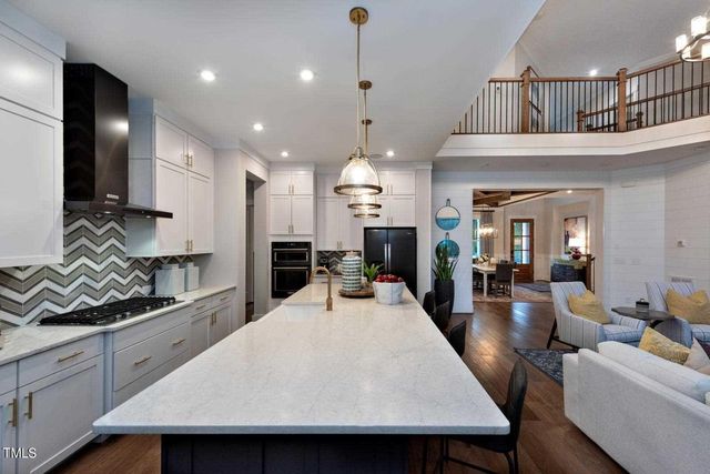 a large kitchen with a table and chairs