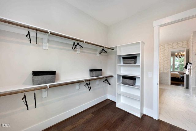 a view of a hallway with a table and chairs