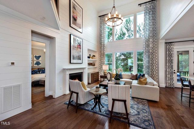 a living room with fireplace furniture and a wooden floor