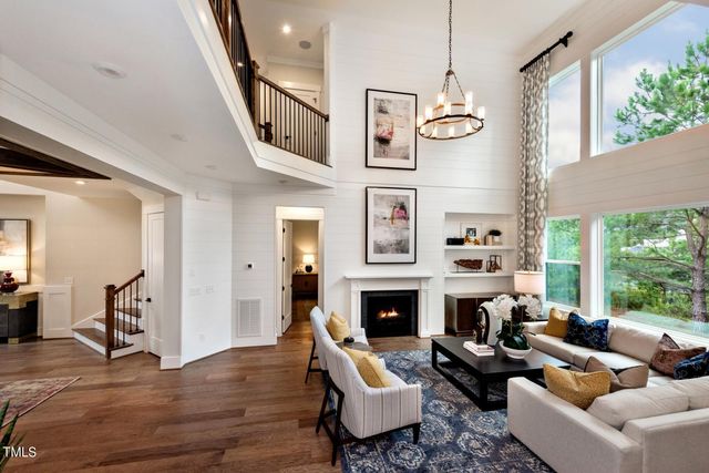 a living room with furniture fireplace and a large window
