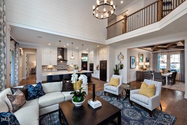 a living room with fireplace furniture and a chandelier
