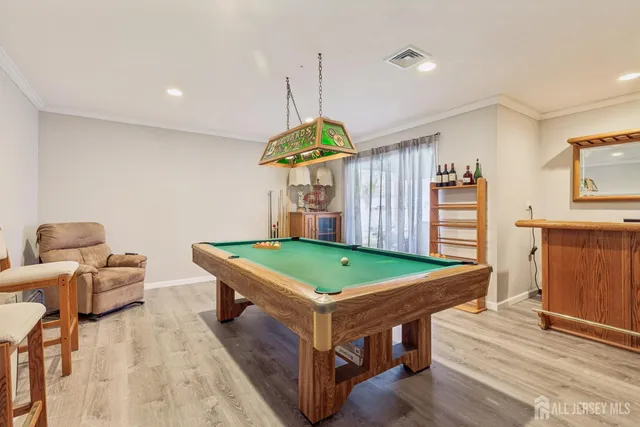 a room with pool table and windows