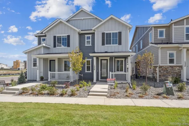 a front view of a house with a yard and porch