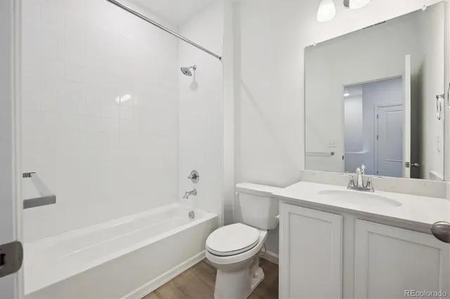 a bathroom with a sink toilet vanity and shower