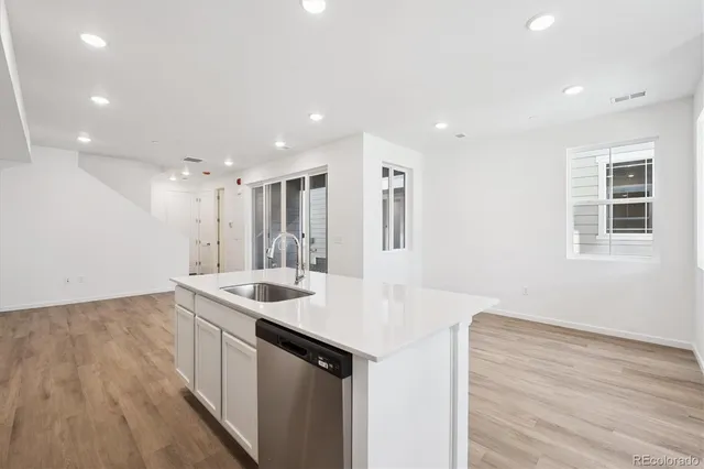 a kitchen with a sink appliances and cabinets