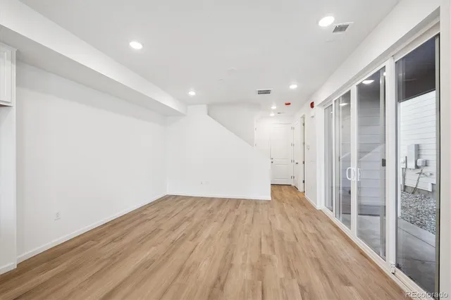 a view of hallway with wooden floor