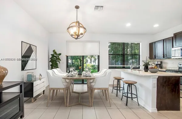 a view of a dining room that has a table and chairs in it