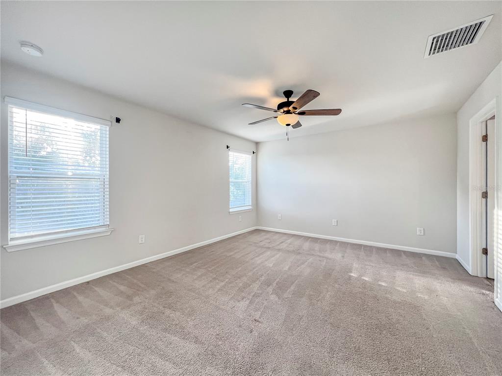 8511 Rain Lily Crossing Parrish, FL 34219 - Photo 19 of 34 a view of an empty room with a window