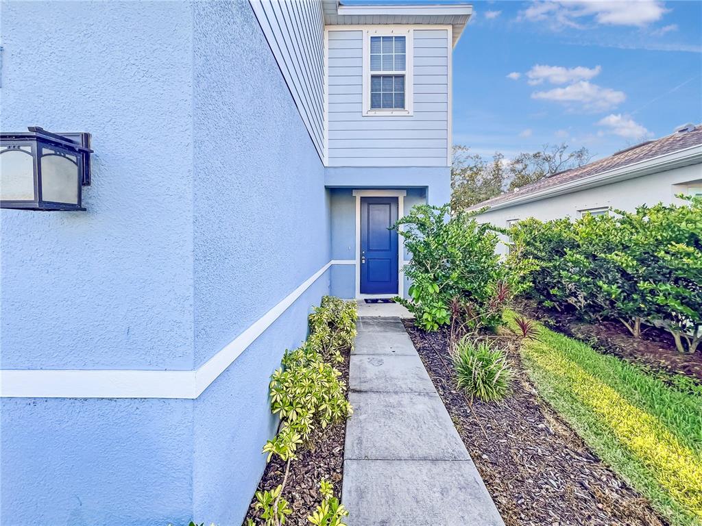 8511 Rain Lily Crossing Parrish, FL 34219 - Photo 2 of 34 a view of a pathway with house on both side
