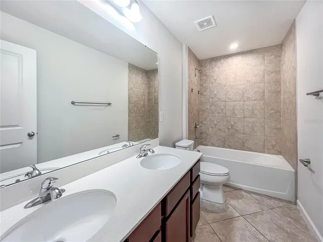 a bathroom with a bathtub shower sink and toilet