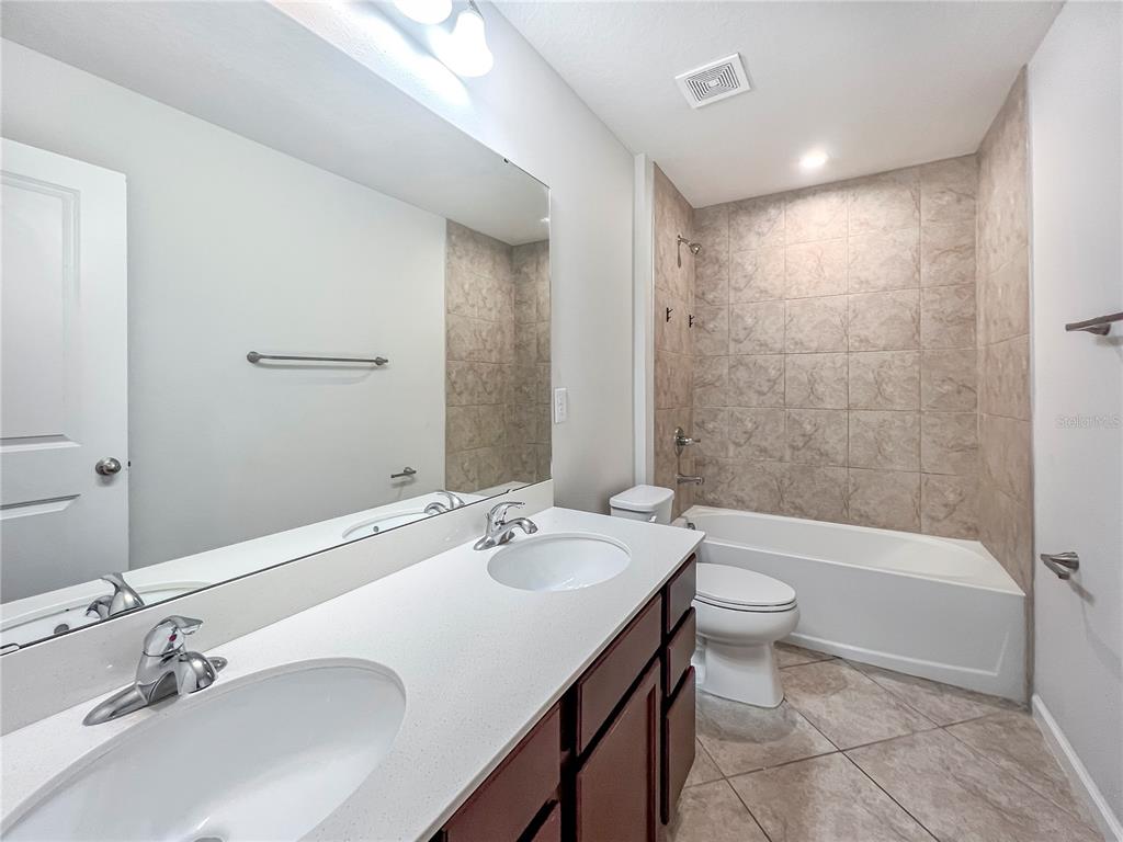 8511 Rain Lily Crossing Parrish, FL 34219 - Photo 29 of 34 a bathroom with a bathtub shower sink and toilet