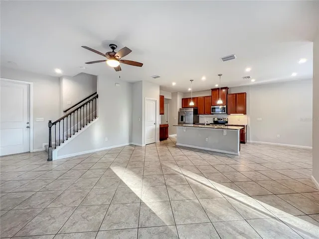 a view of a kitchen with a sink and a chandelier